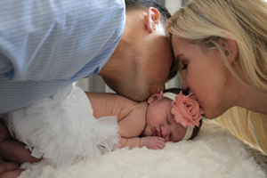 Parents Kissing Babygirl